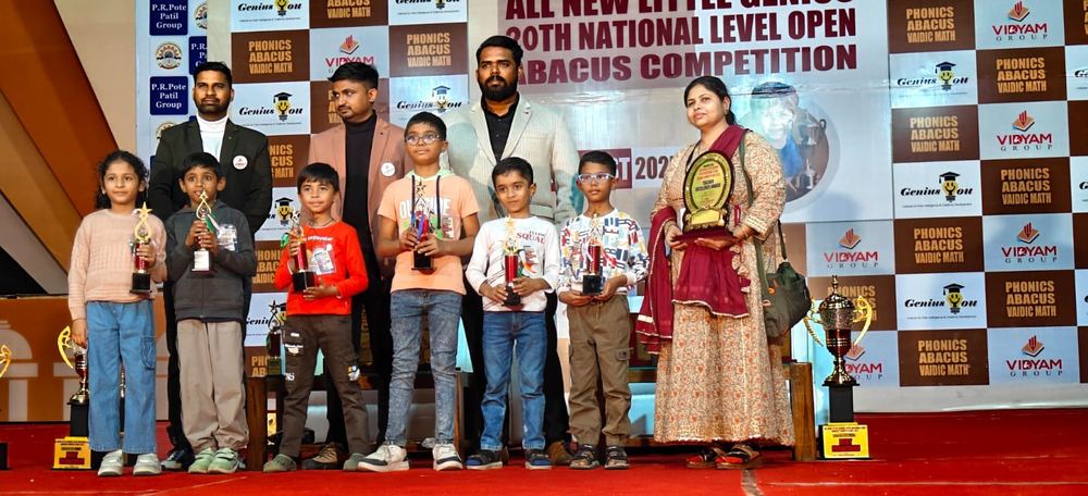 Students with trophies on stage at abacus competition award ceremony