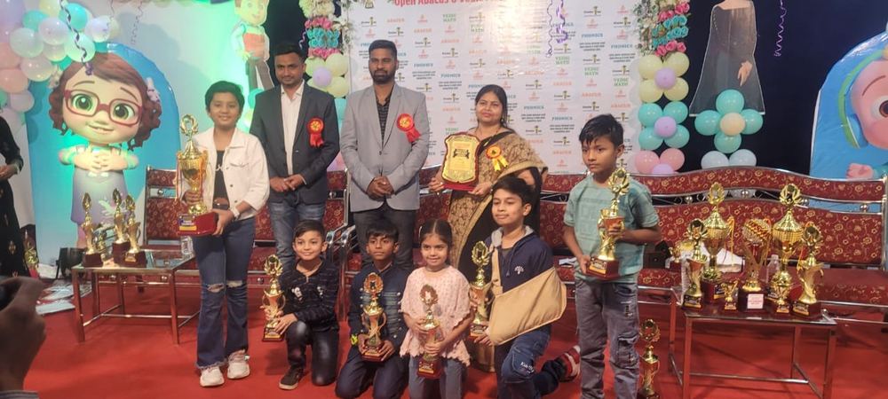 Students with trophies at competition stage with decorations
