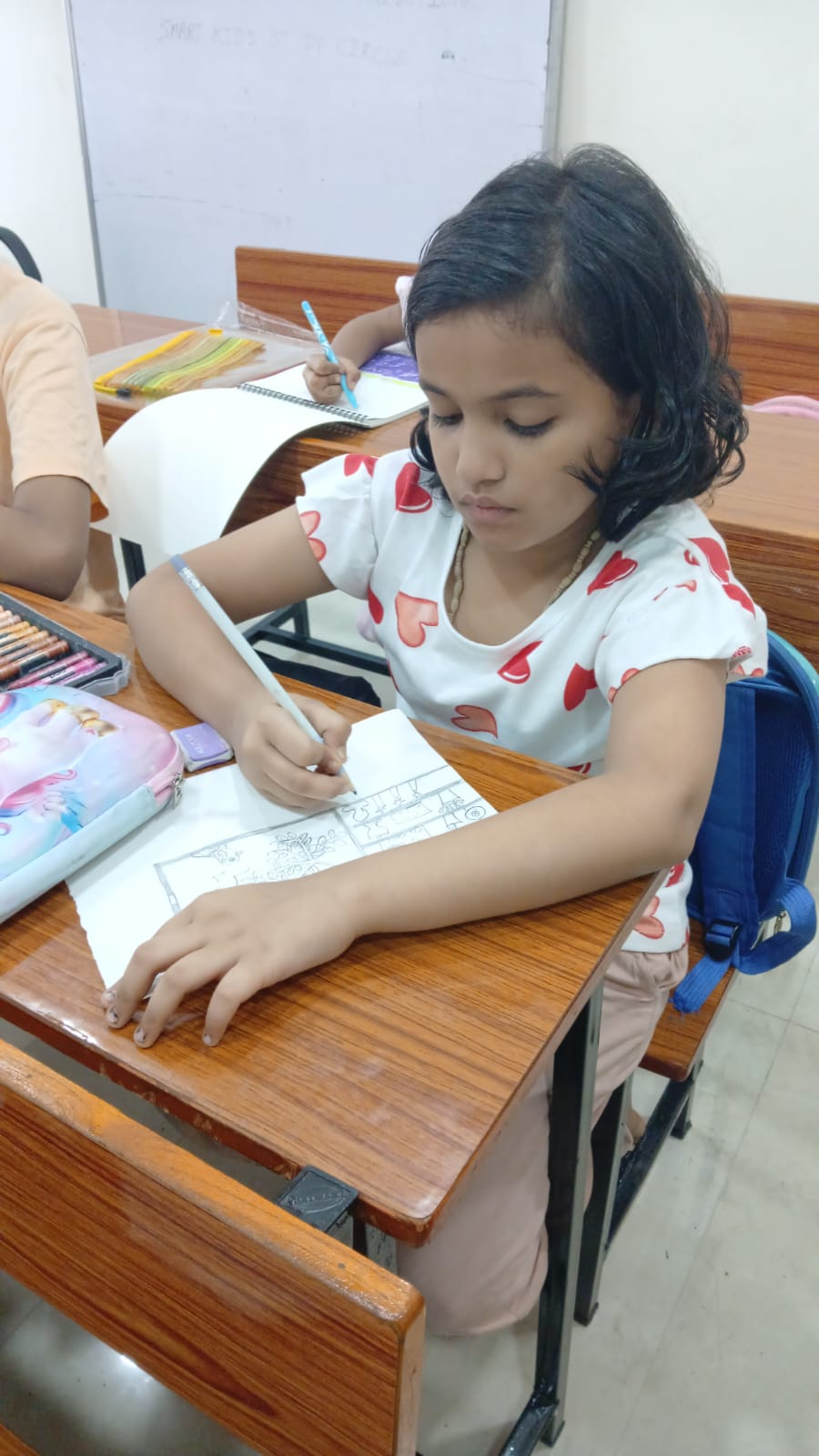 Student selecting sketch pens for art activity at Smart Kids Study Circle workshop